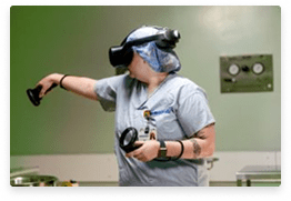 Woman in scrubs wearing a virtual reality headset, engaged in immersive training or simulation in a healthcare setting.